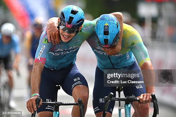 Alessio Delle Vedove of Italy and Gleb Syritsa of Russia and Team XDS Astana Team celebrate the victory of his teammate Aaron Gate of New Zealand...