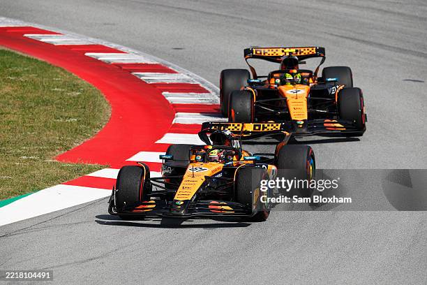 Oscar Piastri of Australia driving the McLaren MCL39 Mercedes leads Lando Norris of Great Britain driving the McLaren MCL39 Mercedes on track during...