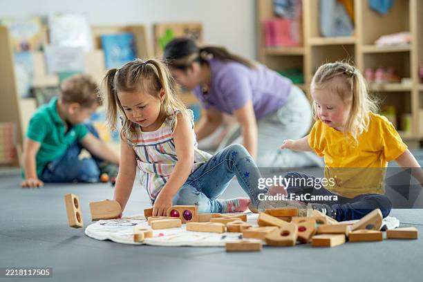 children engaged in creative playtime at a vibrant daycare setting - child care workers stock pictures, royalty-free photos & images