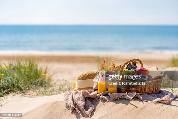 coze picnic on a sand dune by the beach - picnic basket stock pictures, royalty-free photos & images