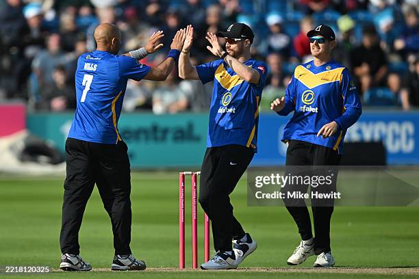 Tymal Mills of Sussex celebrates with Nathan McAndrew and Daniel Hughes after dismissing Miles Hammond of Gloucestershire during the Vitality Blast...