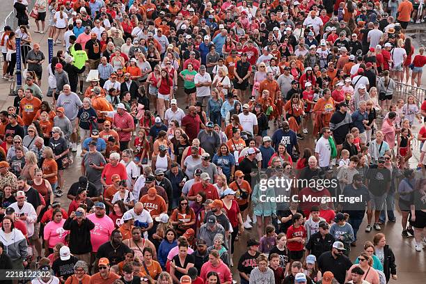 Fans wait in line outside the stadium before game two of the Division I Women's Softball Championship series between the Texas Tech Red Raiders and...