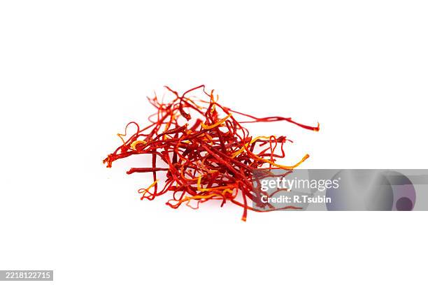 close-up shot of a pile of saffron threads on a plain white background - saffron crocus stock pictures, royalty-free photos & images