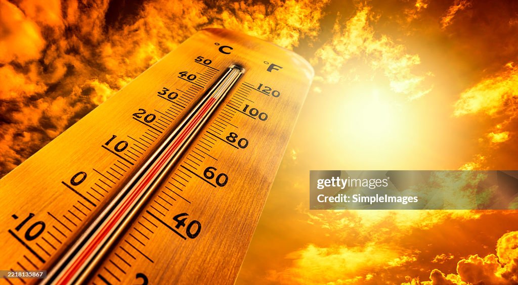 Thermometer showing tropical heat and sky with hot sun rays in Celsius and Fahrenheit