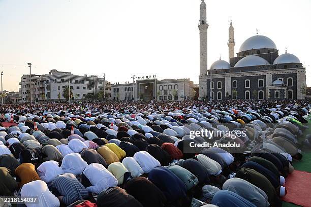 Muslims gather to perform the first Eid al-Adha prayer following the fall of the Bashar al-Assad regime at the Khalid ibn al-Walid Mosque in Homs,...