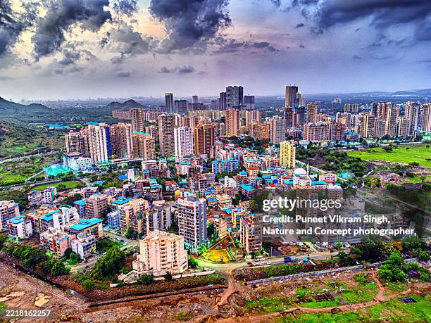 aerial view of developing new megacity during evening hours showing navi mumbai skyline and high rise apartments in kharghar navi mumbai, maharashtra, india. - mumbai stock pictures, royalty-free photos & images