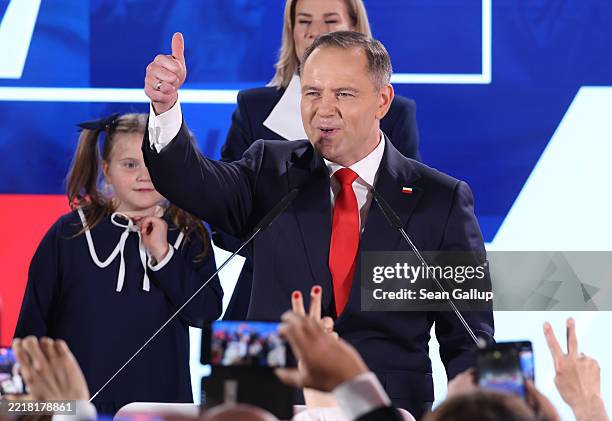 Karol Nawrocki, presidential candidate of the Law and Justice Party , gestures to supporters following the Polish presidential runoff election on...