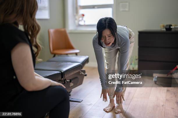 physiotherapie-sitzung mit behandler und patient in einer wellness-klinik - biomechanik stock-fotos und bilder