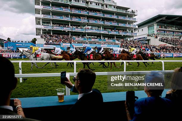 The field pass the Queen Elizabeth Stand at the finish of the Betfred Nifty 50 Handicap on the first day of the Epsom Derby Festival horse racing...