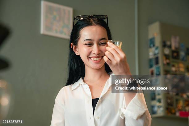 barista mindfully serving a freshly whisked matcha at the counter - taste test stock pictures, royalty-free photos & images