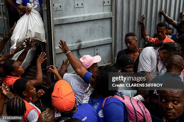 People wait for food at a distribution point at a displacement site in Port-au-Prince, Haiti, June 6, 2025. US President Donald Trump's inclusion of...
