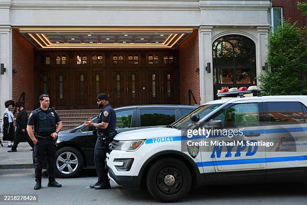 Members of the Orthodox Jewish community walk past NYPD officers as they stand guard outside of Congregation Shaarei Zion of Bobov on June 02, 2025...