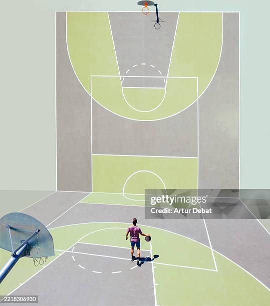 surreal basketball court with a player against adversity in a visual illusion perspective - visual trickery stock pictures, royalty-free photos & images