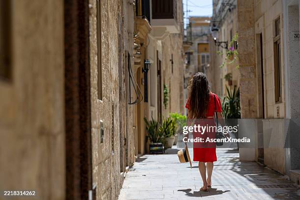 woman explores narrow streets, malta - gozo malta stock pictures, royalty-free photos & images