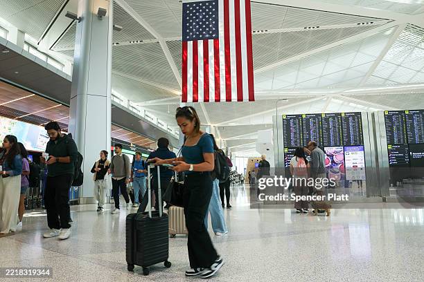 People move through Newark Liberty International Airport following a news conference by Transportation Secretary Sean Duffy at the airport, where he...