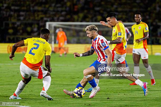 Julio Enciso of Paraguay in action against Carlos Cuesta and Daniel Muñoz of Colombia during the South American FIFA World Cup 2026 Qualifier match...