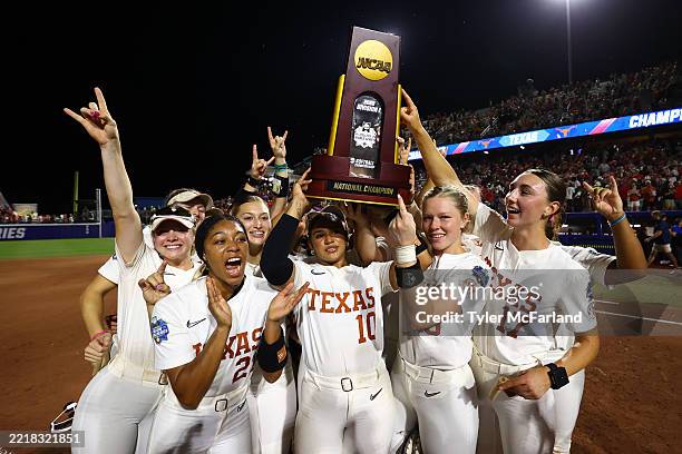 Mia Scott of the Texas Longhorns and teammates celebrate with the National Trophy after defeating the Texas Tech Red Raiders in game three of the...