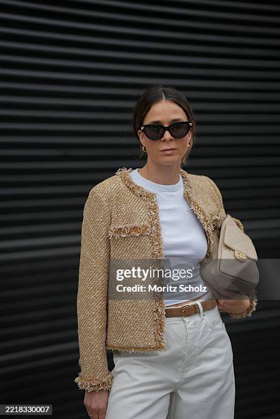 Patricia Wirschke is seen wearing a golden metallic tweed jacket with fringed trims and two pockets in the front from ME+EM, a white lightweight...