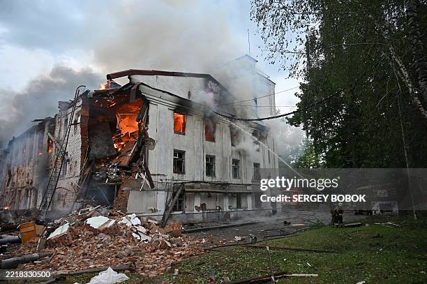 Firefighters extinguish a fire at a civilian plant following powerful attacks to Ukrainian city of Kharkiv early on June 7, 2025. Russia pummelled...