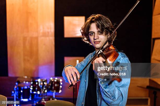 portrait of young male violinist practicing playing - sound engineer stock pictures, royalty-free photos & images