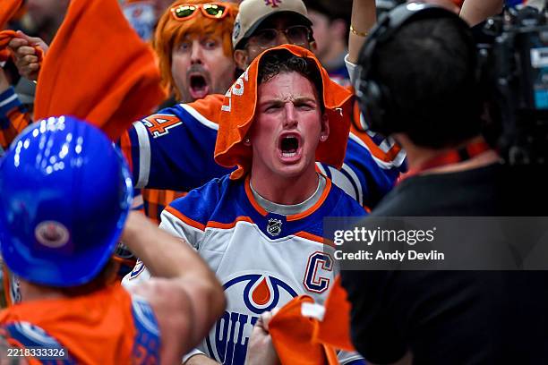 Fan cheers in front of a camera during a stoppage of play in the first overtime period between the Florida Panthers and Edmonton Oilers in Game Two...