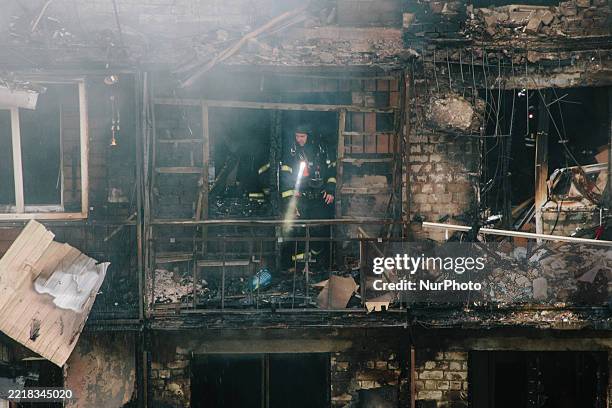 Firefighter inspects the burned-out apartments, in Kharkiv, Ukraine, on June 7, 2025.