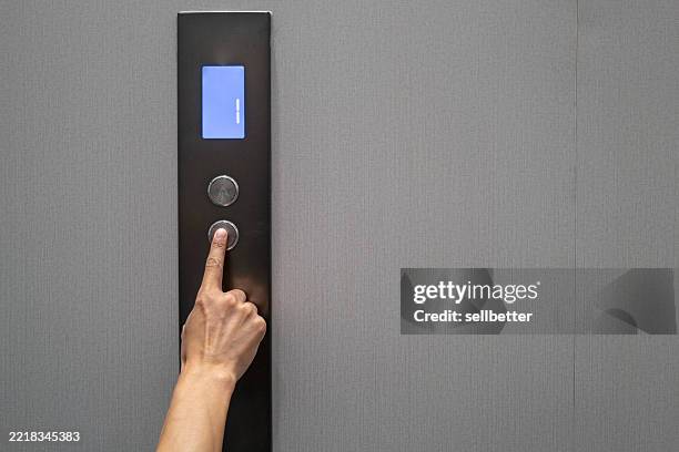 human finger pressing button on elevator panel - inside elevator stock pictures, royalty-free photos & images