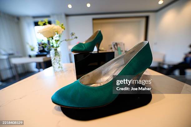 Rayne Green Satin evening pumps are displayed ahead of the largest collection of Diana, Princess of Wales clothing to be auctioned at the Peninsula...