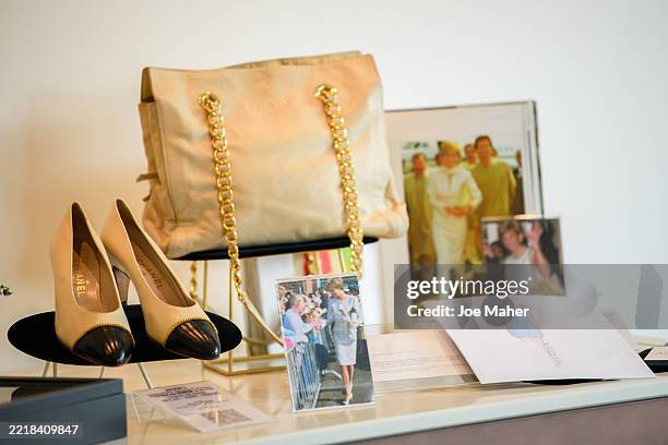 Chanel shoes and a Prada handbag are displayed ahead of the largest collection of Diana, Princess of Wales clothing to be auctioned at the Peninsula...