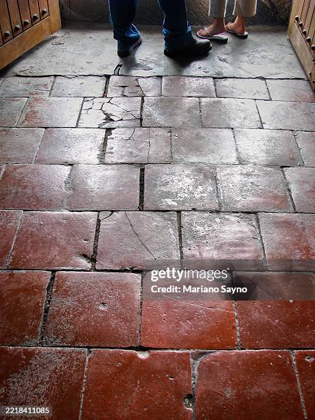 a close-up shows worn, reddish-brown quarry tiles in a rectangular pattern. - flagstone pattern stock pictures, royalty-free photos & images