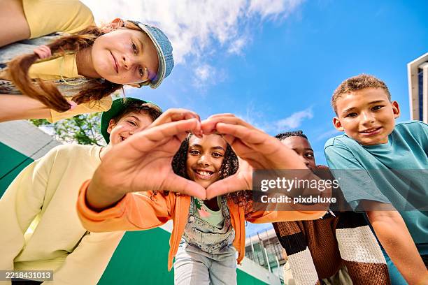 group of school children making heart shape with hands - generation alpha stock pictures, royalty-free photos & images