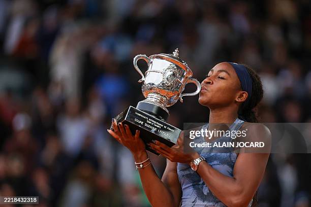 Coco Gauff kisses the trophy after winning her women's singles final match against Belarus' Aryna Sabalenka on day 14 of The French Open tennis...