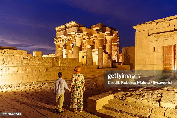 boy with mother exploring the temple of kom ombo - ombo stock pictures, royalty-free photos & images