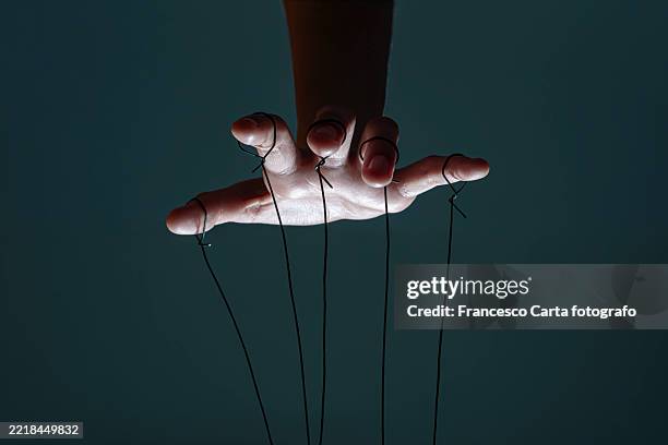 fingers of a puppeteer - exploitatie stockfoto's en -beelden