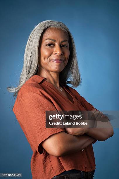 studio portrait of middle aged african american woman - arms crossed stock pictures, royalty-free photos & images