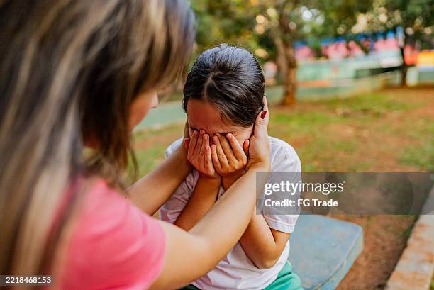 sadness being consoled by mother on the public park - lost stock pictures, royalty-free photos & images
