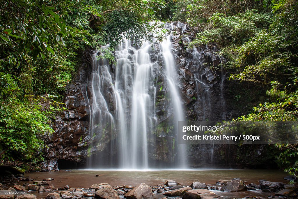 Majestic Waterfall Cascading in Lush Tropical Forest