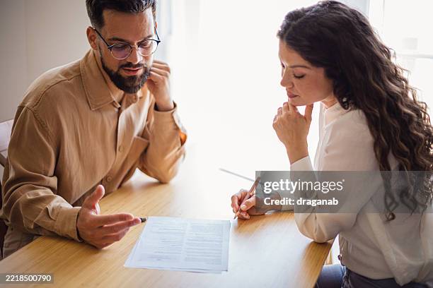 business partners reviewing contract terms and conditions - legal proceeding stock pictures, royalty-free photos & images