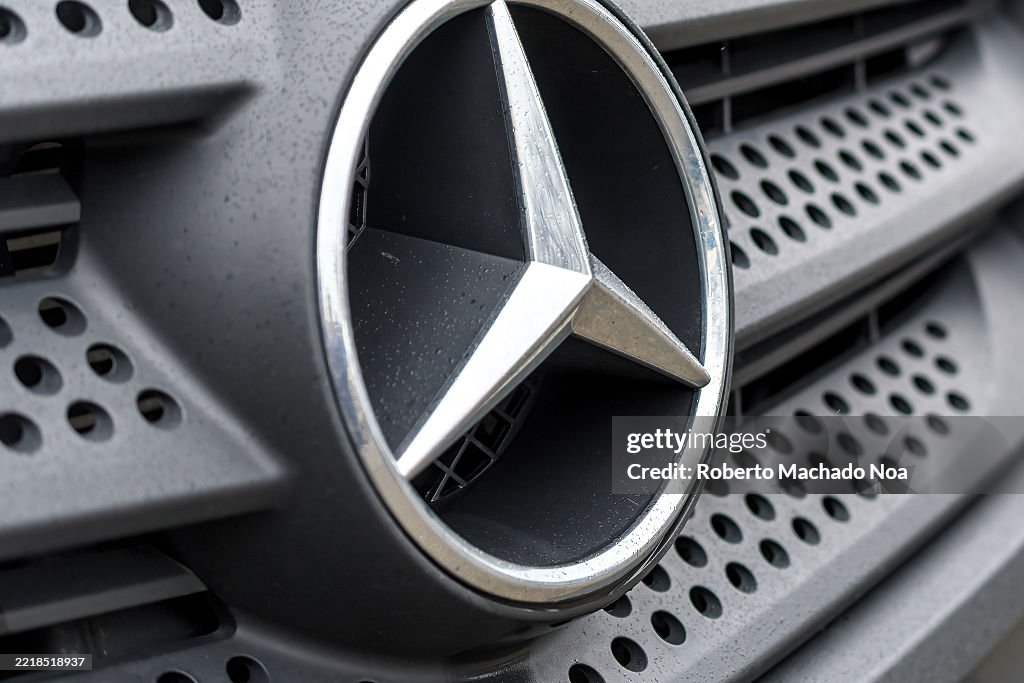 Logo of a Mercedes-Benz car covered in raindrops...