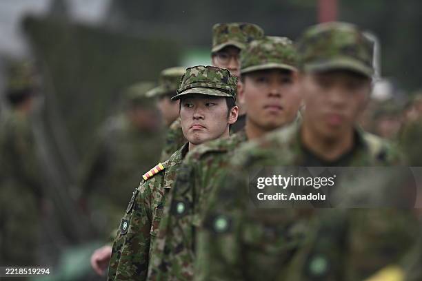 Japanese Self-Defense Forces soldiers take part in an annual military exercise at the Gotenba training ground, beneath Mount Fuji on June 8 in...