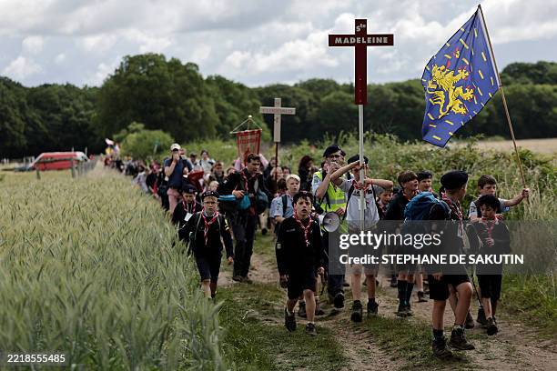 Pelgrins hold crosses, banners and flags as they arrive for the Mass, during the traditional Pentecostal pilgrimage from Paris to Chartres, in...