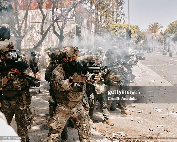 Protests and confrontations between immigration rights supporters and law enforcement are seen taking place in Paramount, California, and downtown...