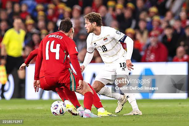 Cardiff, United Kingdom Nicolas Hasler of Liechtenstein looks for options during the FIFA World Cup 2026 European Qualifier match between Wales and...