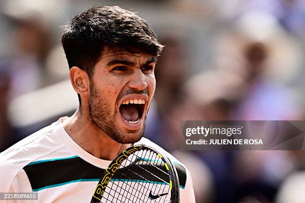 Spain's Carlos Alcaraz reacts after winning a game during his men's singles final match against Italy's Jannik Sinner on day 15 of the French Open...