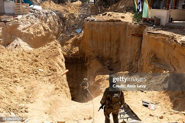 Israeli soldiers exit a tunnel, where the Israeli army believes to be Hamas leader underground infrastructure near the Gaza European Hospital at Khan...