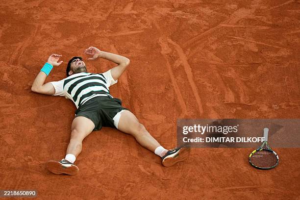 Spain's Carlos Alcaraz celebrates after winning the men's singles final match against Italy's Jannik Sinner on day 15 of the French Open tennis...