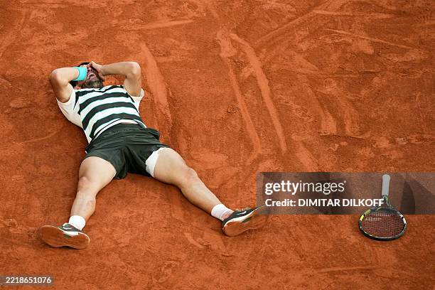 Spain's Carlos Alcaraz celebrates after winning the men's singles final match against Italy's Jannik Sinner on day 15 of the French Open tennis...
