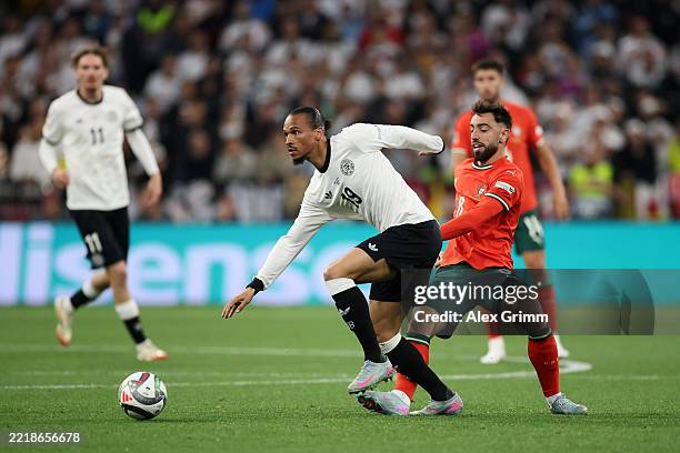 Leroy Sane of Germany is challenged by Bruno Fernandes of Portugal during the UEFA Nations League 2025 semifinal match between Germany and Portugal...