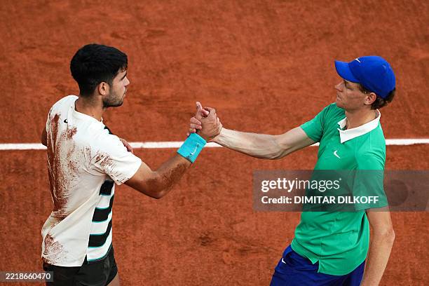 Spain's Carlos Alcaraz shakes hands with Italy's Jannik Sinner after winning the men's singles final match on day 15 of the French Open tennis...