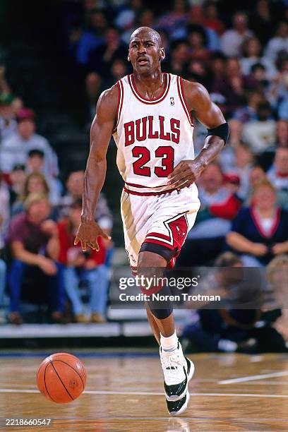 Michael Jordan of the Chicago Bulls dribbles during a game against the Seattle SuperSonics on October 23, 1996 at the United Center in Chicago,...